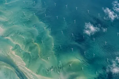 Aerial Offshore Wind Farm Over Turquoise Sea