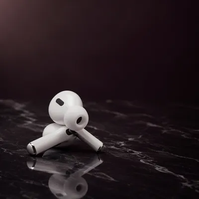 Minimal White Earbuds on Dark Marble