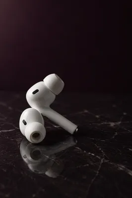 Minimal White Earbuds on Dark Marble