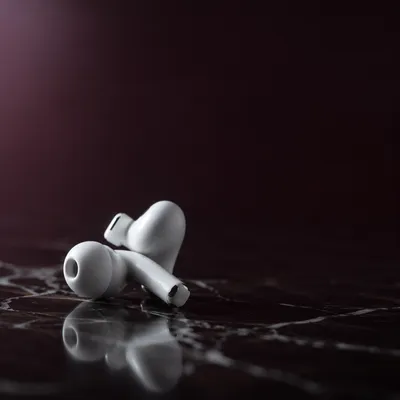 Minimal White Earbuds on Dark Marble