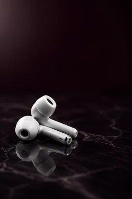 Minimal White Earbuds on Dark Marble
