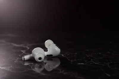 Minimal White Earbuds on Dark Marble