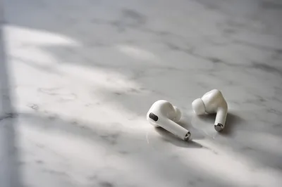 Minimal Wireless Earbuds on White Marble