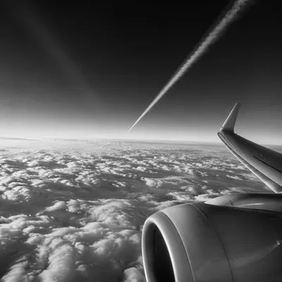 Monochrome Airplane Window Above Dramatic Clouds