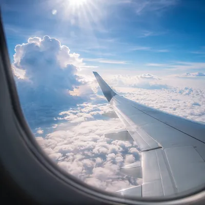 Airplane Wing Above Peaceful Cloudscape