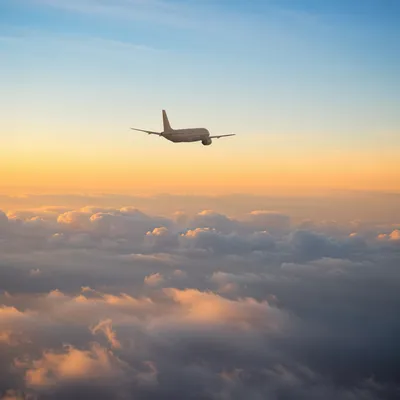 Airplane Above Clouds at Peaceful Sunrise