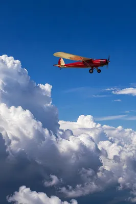 Vintage Airplane Above Dramatic Cloudscape