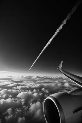Monochrome Airplane Wing Over Dramatic Clouds
