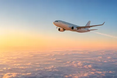 Passenger Airplane Above Sunrise Cloudscape