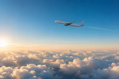Passenger Airplane Above Sunlit Clouds