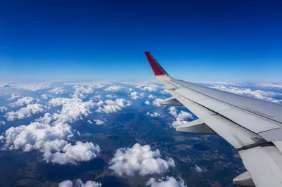 Airplane Wing Above Bright Cloud Layers