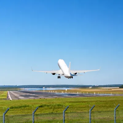 Airplane Taking Off Under Clear Blue Sky