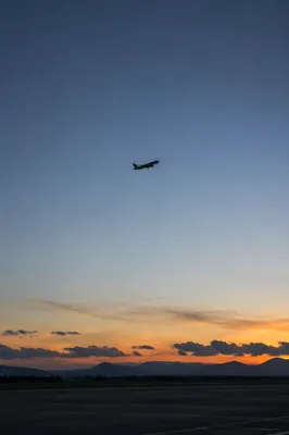 Airplane Taking Off Into Blue Dawn Sky