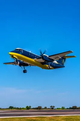 Propeller Airplane Takeoff Under Clear Blue Sky
