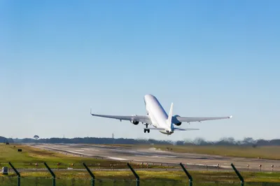 Passenger Airplane Taking Off Under Blue Sky