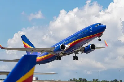 Passenger Airplane Taking Off Into Blue Sky