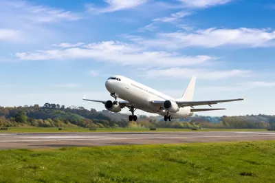 Passenger Airplane Takeoff Under Bright Blue Sky