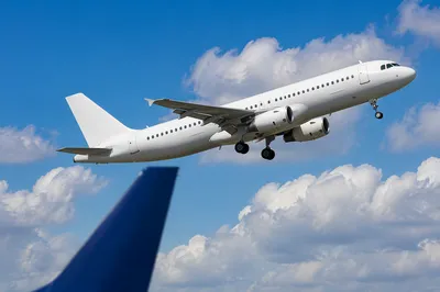 Passenger Jet Taking Off Under Blue Sky