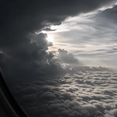 Dramatic Airplane Window View Above Clouds