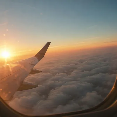 Sunset Airplane Window View Above Clouds