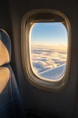 Sunlit Clouds Through Airplane Window