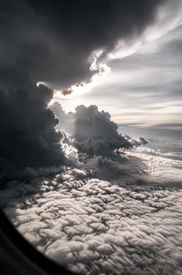 Dramatic Airplane Window View Above Clouds