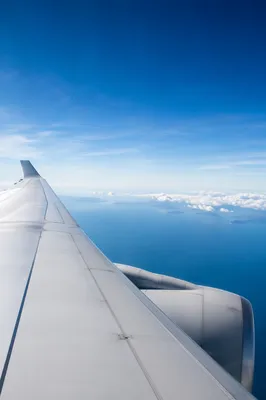 Airplane Window View Above Ocean Clouds
