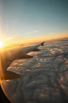 Golden Sunset Airplane Window Above Clouds