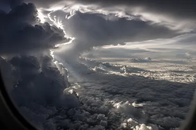 Dramatic Airplane Window View Above Clouds