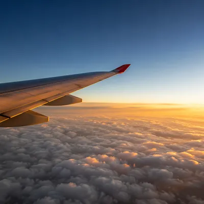 Sunrise Airplane Wing Above Soft Clouds