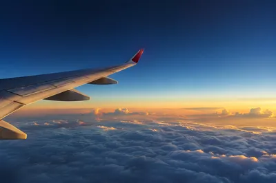Sunrise Airplane Wing Above Soft Clouds