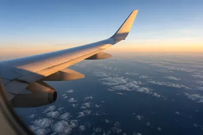 Sunrise Airplane Wing Above Clouds View