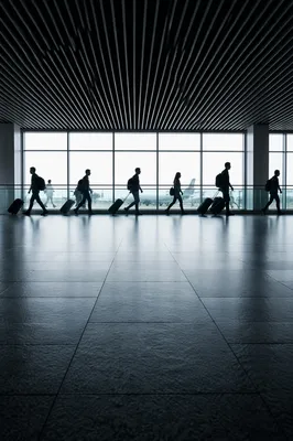 Silhouetted Travelers in Modern Airport Terminal