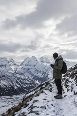 Lone Hiker on Snowy Alpine Ridge