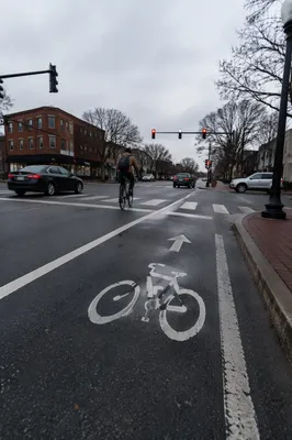 Urban Bicycle Commute at Rainy Intersection