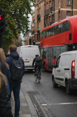 Urban Cyclist Commuting Through Busy Street