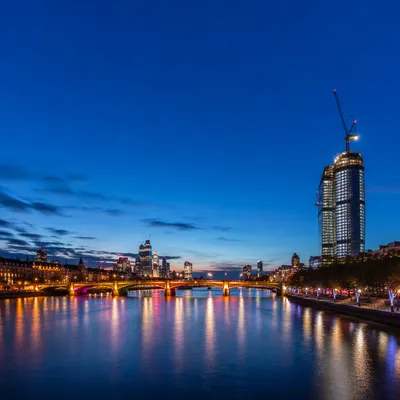 Illuminated Bridge Over River at Blue Hour