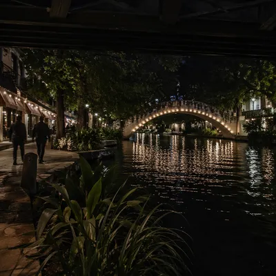 Glowing Bridge Over Quiet River at Night