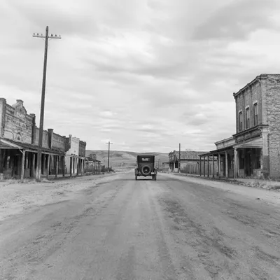 Vintage Car on Dusty Rural Highway