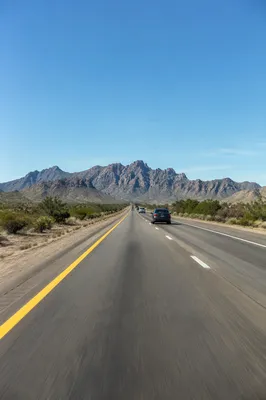 Desert Highway Road Trip Toward Mountains