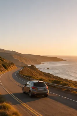 Compact Car on Coastal Highway at Sunset
