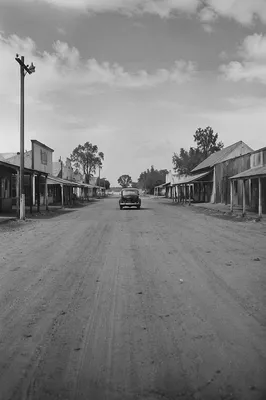 Vintage Car on Dusty Rural Highway