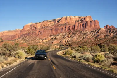 Desert Highway Road Trip with Red Cliffs
