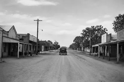 Vintage Car on Dusty Rural Highway