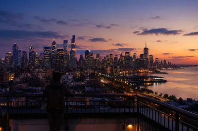 Contemplative Traveler Over City Skyline