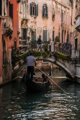 Venetian Gondola Beneath Arched Canal Bridge