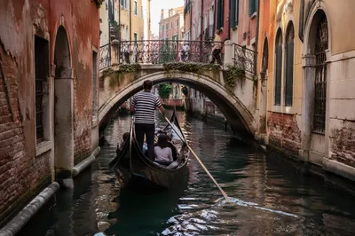 Black Gondola Beneath Venetian Stone Bridge
