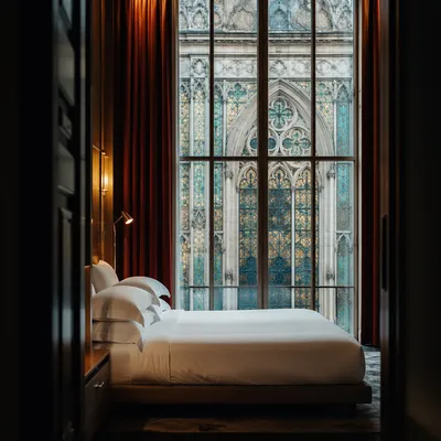 Luxury Hotel Bed with Stained Glass View