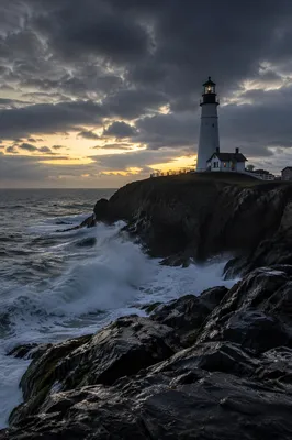 Dramatic Lighthouse on Rocky Coast at Blue Hour