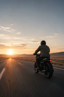 Lone Motorcycle Riding Desert Highway at Sunrise